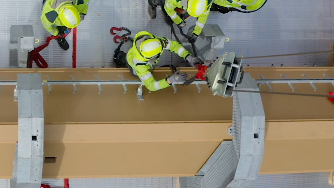 Construction workers from Cteam performing precision assembly on structural steel beam. Construction workers from Cteam performing precision assembly on structural steel beam.