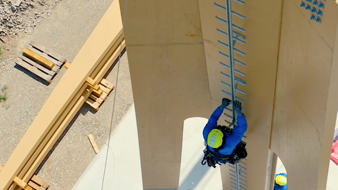 Cteam professional climbing a tall structure ladder, highlighting construction and access solutions. Cteam professional climbing a tall structure ladder, highlighting construction and access solutions.